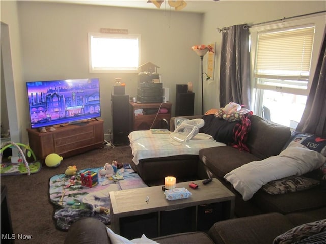 carpeted living room with ceiling fan