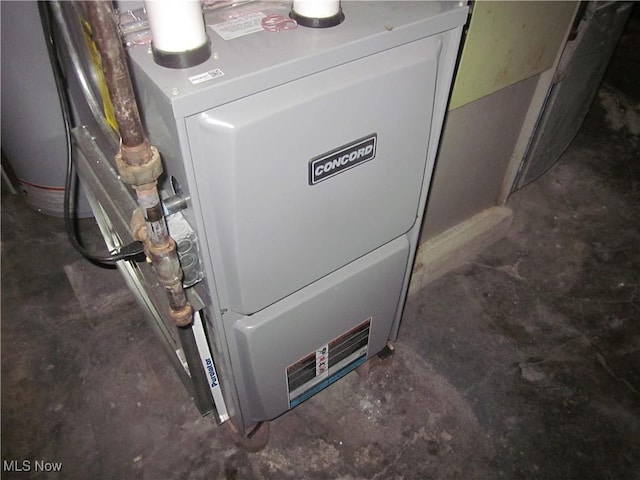utility room featuring heating unit
