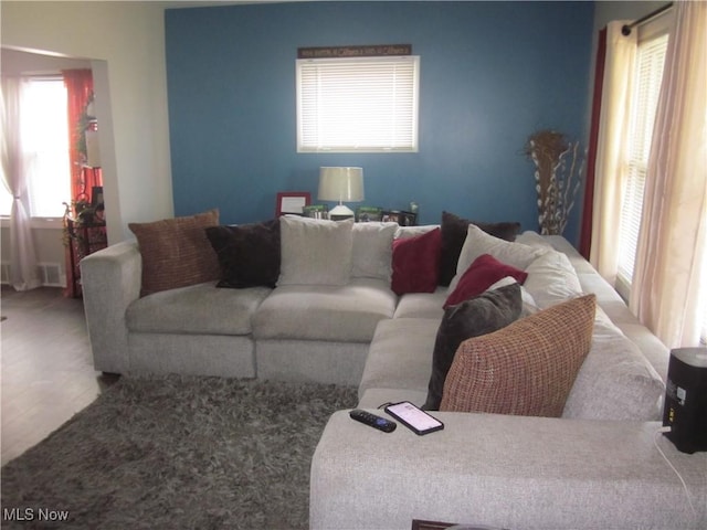 living room with visible vents and a healthy amount of sunlight