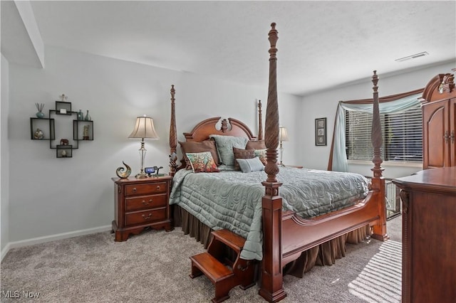 bedroom featuring visible vents, light carpet, and baseboards