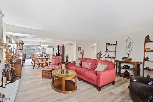 living area with a chandelier and light wood finished floors