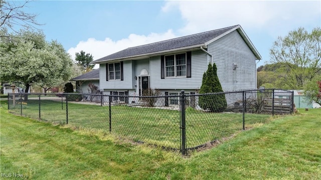 raised ranch featuring a front yard and fence