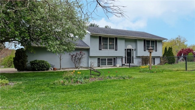 view of front of house with a front lawn and fence