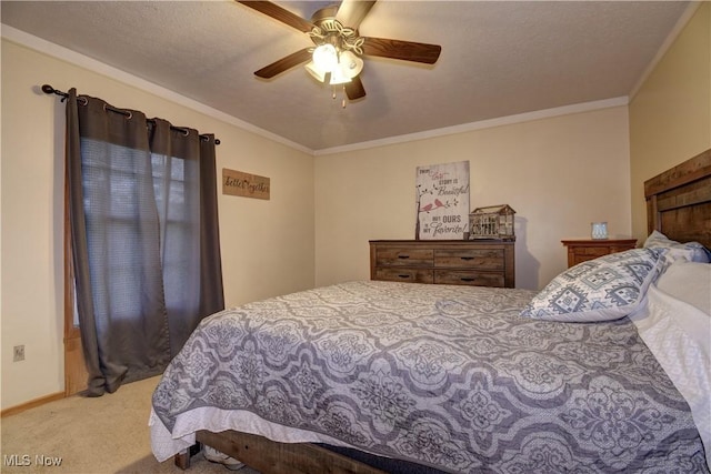 carpeted bedroom with ornamental molding and a ceiling fan
