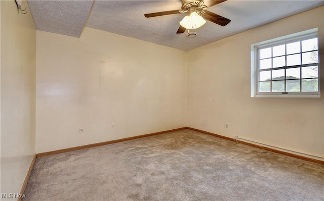 carpeted empty room featuring baseboards, a ceiling fan, and a textured ceiling