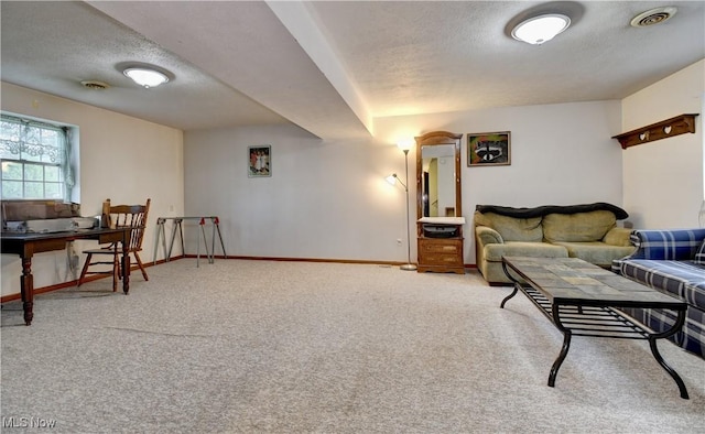 living room with a textured ceiling, visible vents, carpet flooring, and baseboards
