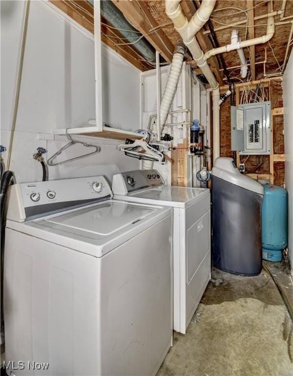 washroom featuring washing machine and dryer, electric panel, and laundry area