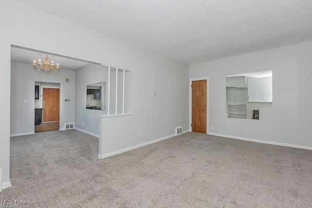 interior space featuring visible vents, a chandelier, carpet flooring, and baseboards