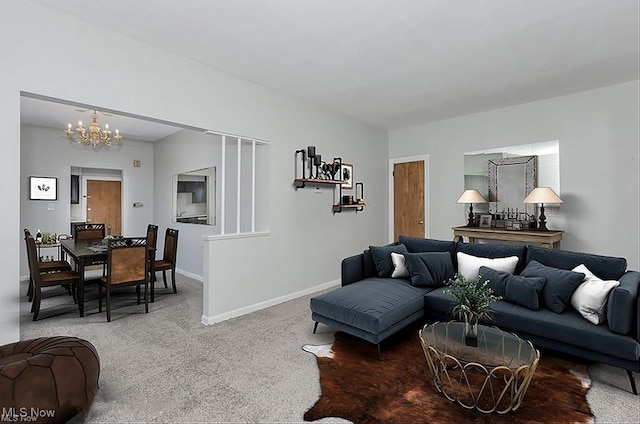 living room featuring baseboards, a notable chandelier, and carpet