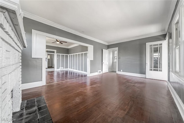 unfurnished living room featuring ornamental molding, ceiling fan, wood finished floors, and baseboards
