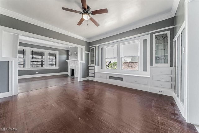 unfurnished living room with a fireplace, hardwood / wood-style floors, crown molding, and a ceiling fan