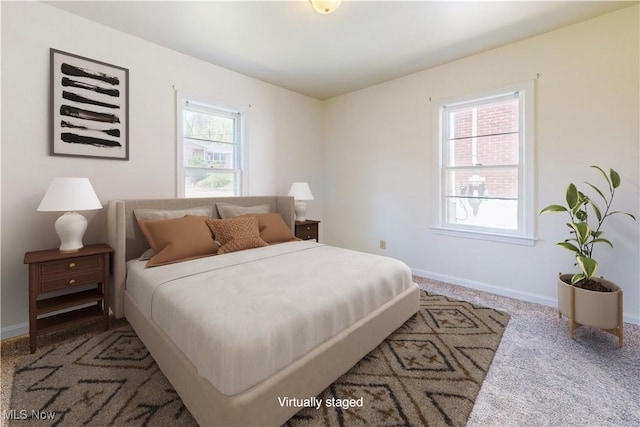 bedroom with carpet flooring and baseboards