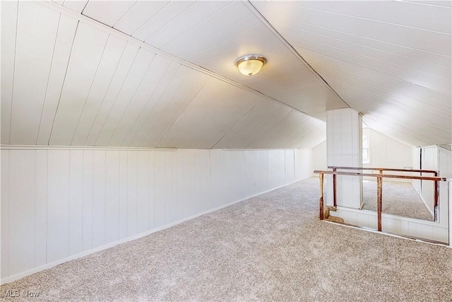 additional living space with carpet and vaulted ceiling