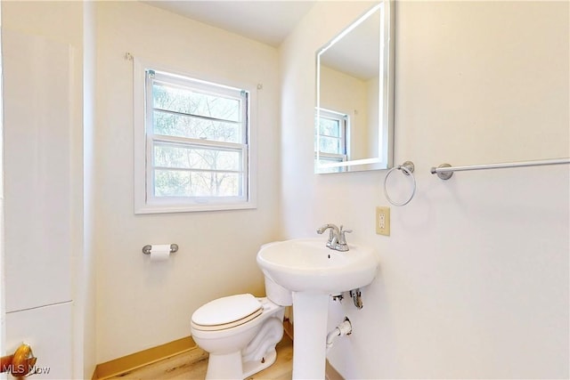 half bath with toilet and baseboards