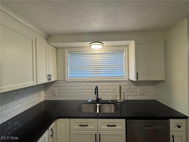 kitchen with a sink, dark countertops, dishwashing machine, and decorative backsplash