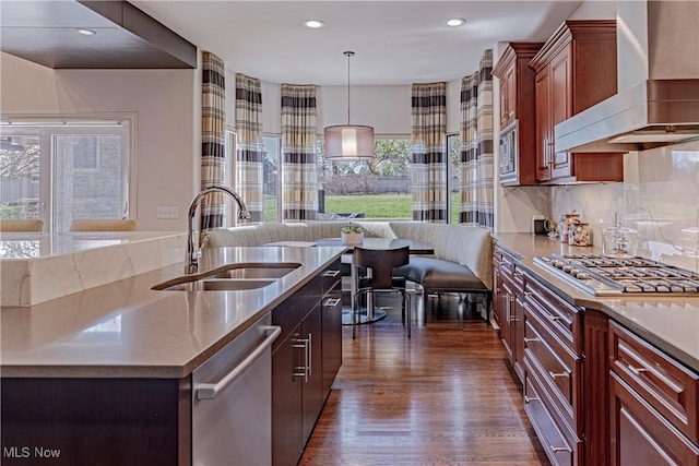 3601 Chapelton Ct, Richfield, OH 44286 - kitchen featuring wall chimney range hood, a sink, appliances with stainless steel finishes, open floor plan, and dark wood-style floors