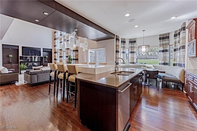 3601 Chapelton Ct, Richfield, OH 44286 - kitchen with open floor plan, a sink, dark wood finished floors, an island with sink, and a kitchen breakfast bar