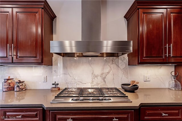 3601 Chapelton Ct, Richfield, OH 44286 - kitchen with wall chimney range hood, stainless steel gas cooktop, decorative backsplash, and dark brown cabinets