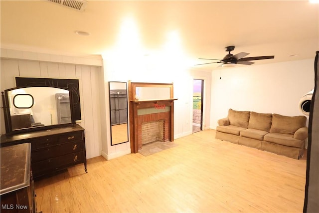 30 Nesbitt St, Poland, OH 44514 - living area with ceiling fan, a tiled fireplace, baseboards, wood finished floors, and visible vents