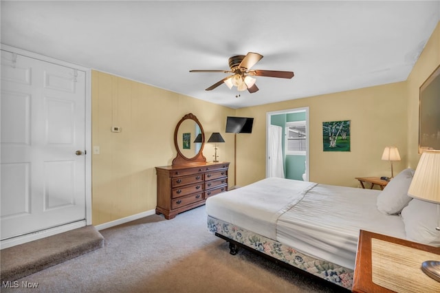 carpeted bedroom with a ceiling fan and baseboards