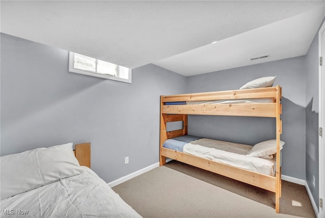 carpeted bedroom with baseboards and visible vents