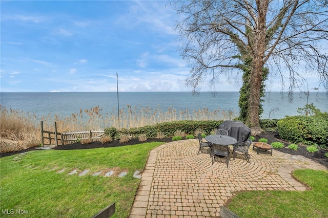 water view with fence and an outdoor fire pit