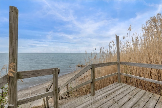 wooden deck featuring a water view