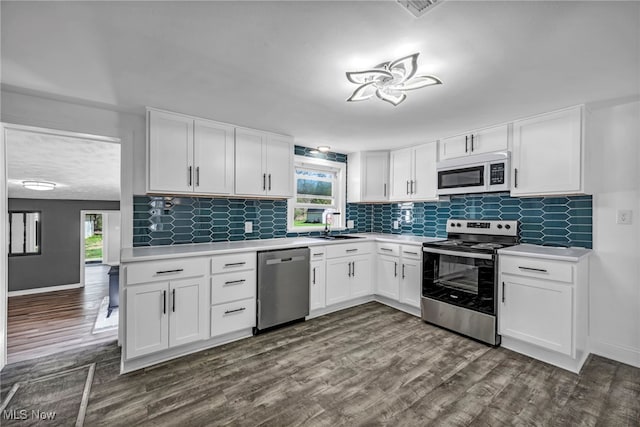 162 E Hamilton St, Oberlin, OH 44074 - kitchen with light countertops, appliances with stainless steel finishes, dark wood-style flooring, and white cabinetry
