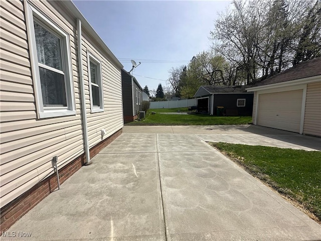 exterior space with a patio, a yard, and a garage
