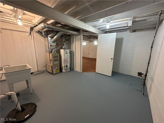 basement with gas water heater and concrete block wall