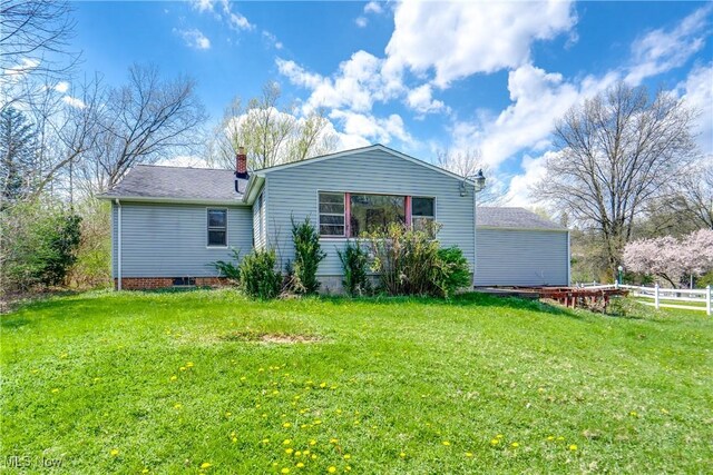 1893 Ridge Rd, Hinckley, OH 44233 - rear view of house with a chimney, fence, and a lawn