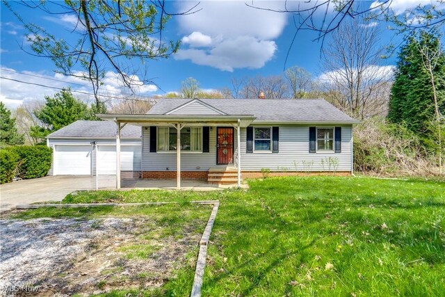 1893 Ridge Rd, Hinckley, OH 44233 - ranch-style house featuring a front yard, a garage, a shingled roof, covered porch, and concrete driveway