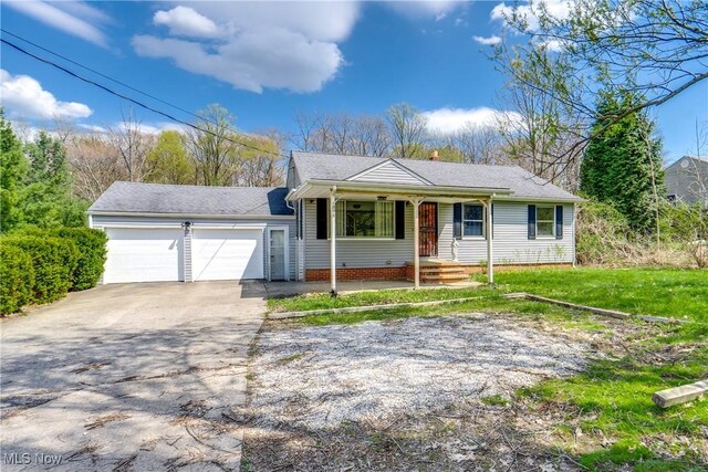 1893 Ridge Rd, Hinckley, OH 44233 - ranch-style home featuring driveway, an attached garage, covered porch, and roof with shingles