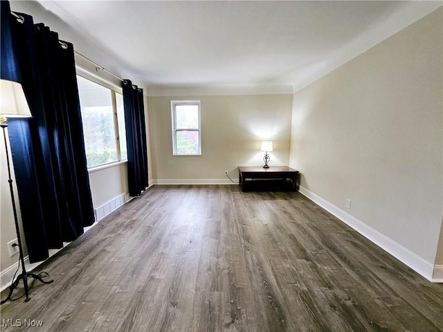 1893 Ridge Rd, Hinckley, OH 44233 - empty room featuring baseboards, visible vents, and dark wood-type flooring