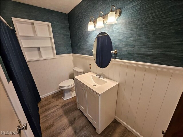 1893 Ridge Rd, Hinckley, OH 44233 - full bath with wood finished floors, toilet, a wainscoted wall, and vanity