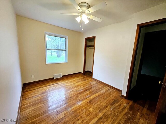 1893 Ridge Rd, Hinckley, OH 44233 - unfurnished bedroom featuring baseboards, visible vents, hardwood / wood-style flooring, and a closet