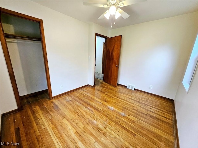 1893 Ridge Rd, Hinckley, OH 44233 - unfurnished bedroom featuring light wood finished floors, a closet, ceiling fan, visible vents, and baseboards