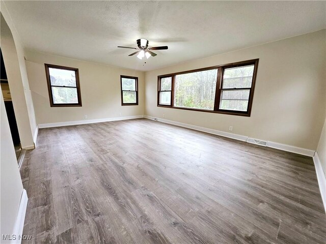 1893 Ridge Rd, Hinckley, OH 44233 - unfurnished room featuring dark wood-style floors, a ceiling fan, and baseboards