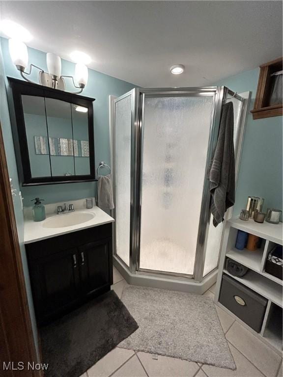 bathroom featuring vanity, tile patterned floors, and a stall shower