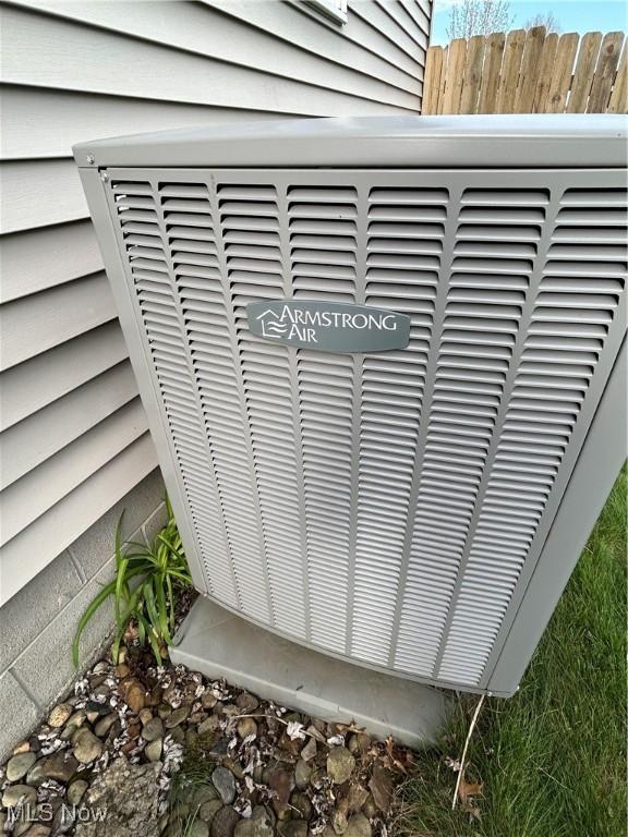 exterior details featuring fence and central AC unit