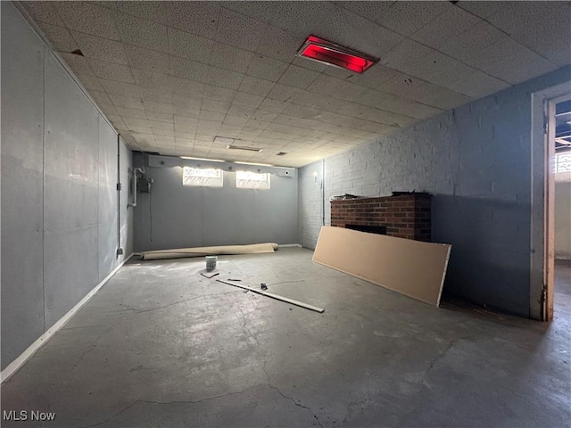basement featuring a brick fireplace