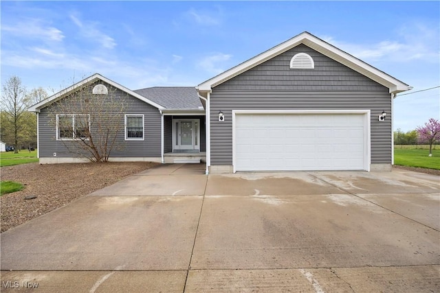 ranch-style house featuring a garage and driveway