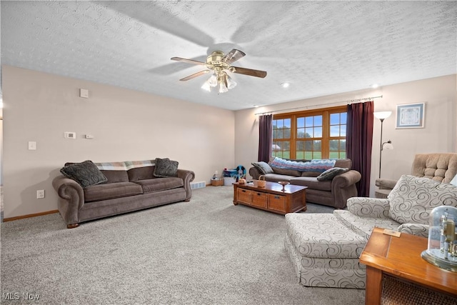 carpeted living area featuring a textured ceiling, ceiling fan, visible vents, and baseboards