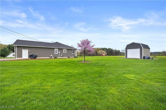 view of yard with a storage shed, a detached garage, and an outbuilding