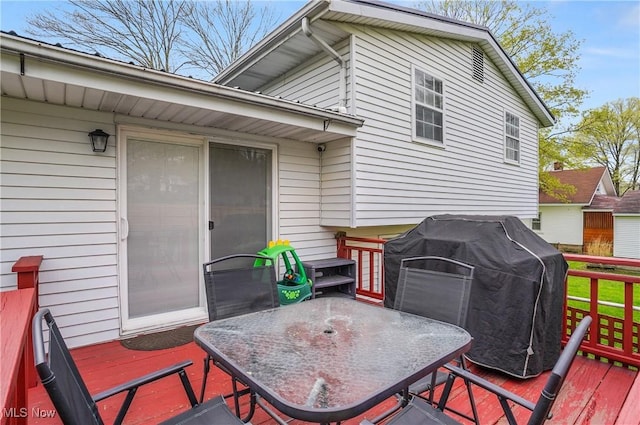 wooden deck featuring area for grilling and outdoor dining area