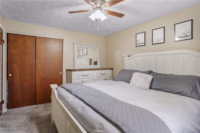 carpeted bedroom with a textured ceiling, ceiling fan, and a closet