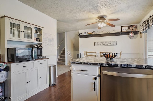 kitchen featuring black microwave, ceiling fan, dark countertops, and dishwasher