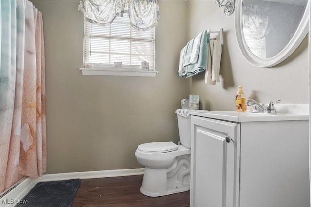 bathroom with a shower with curtain, vanity, toilet, baseboards, and wood finished floors