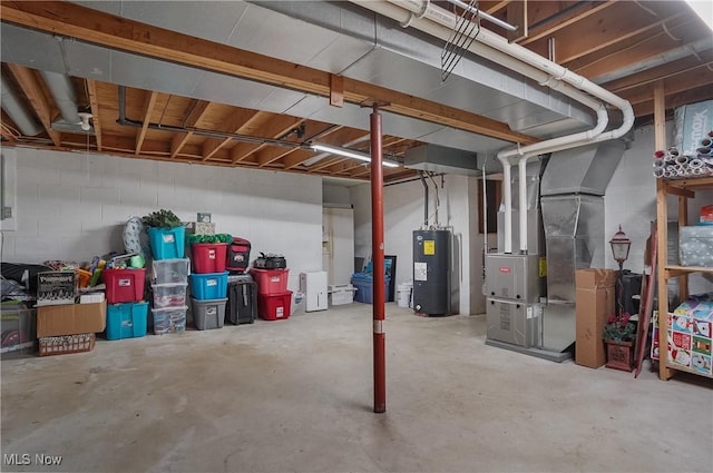 unfinished below grade area with heating unit and electric water heater
