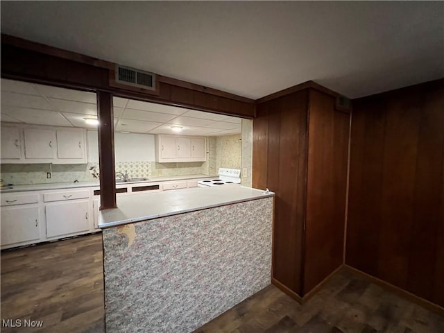 kitchen with visible vents, dark wood-style floors, white electric range, light countertops, and white cabinetry